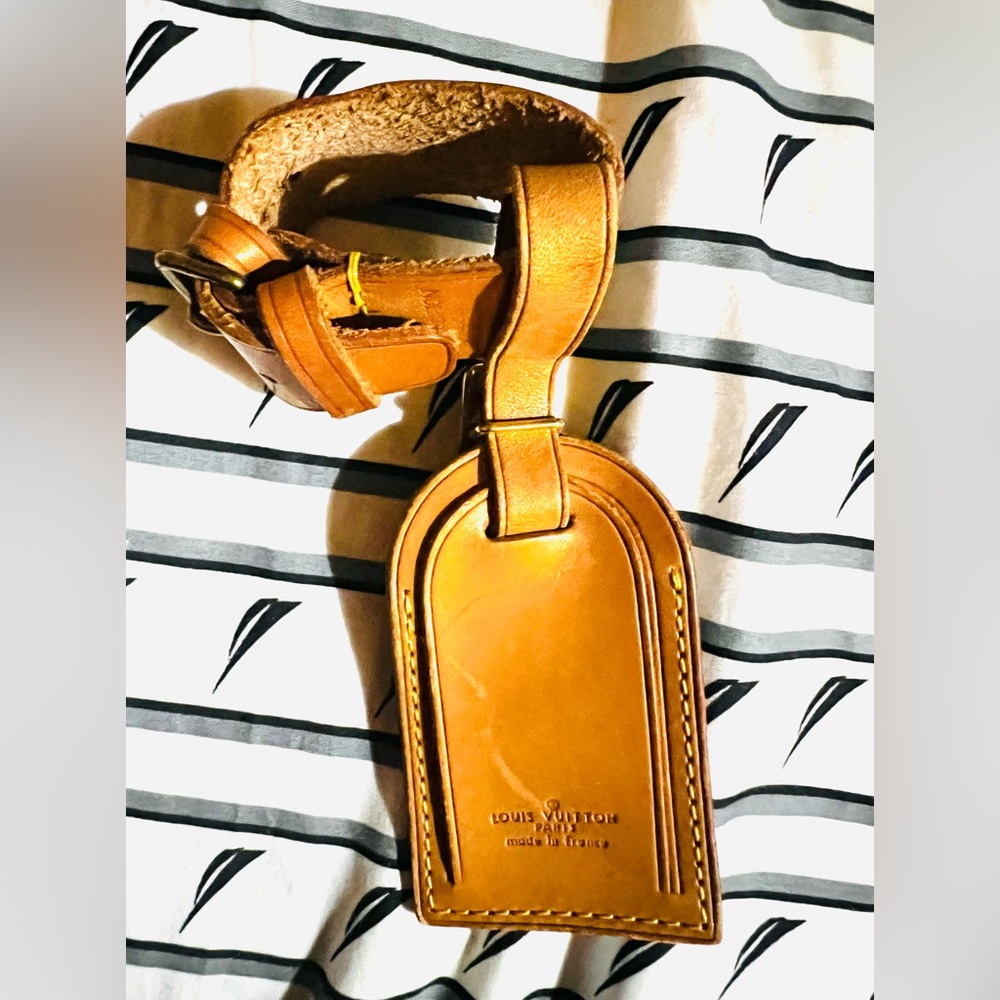 Authentic Louis Vuitton LV Name Tag and Poignet set Pre-owned.
